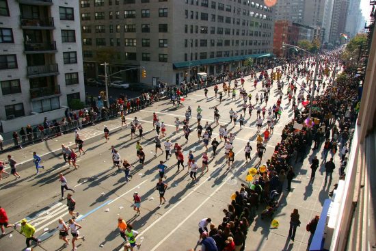 Athletes running a marathon through a city street