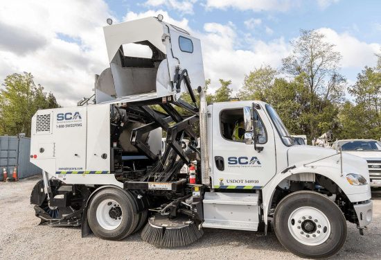Side view of a sweeping truck