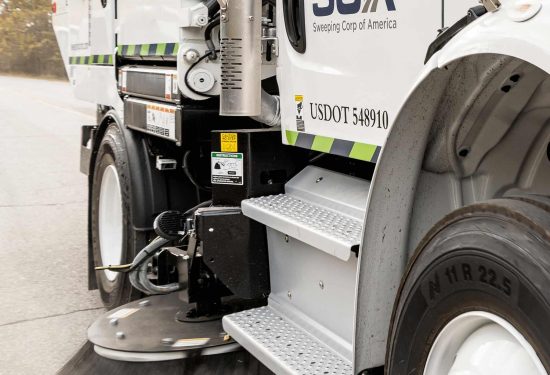 A sweeper truck cleaning a street