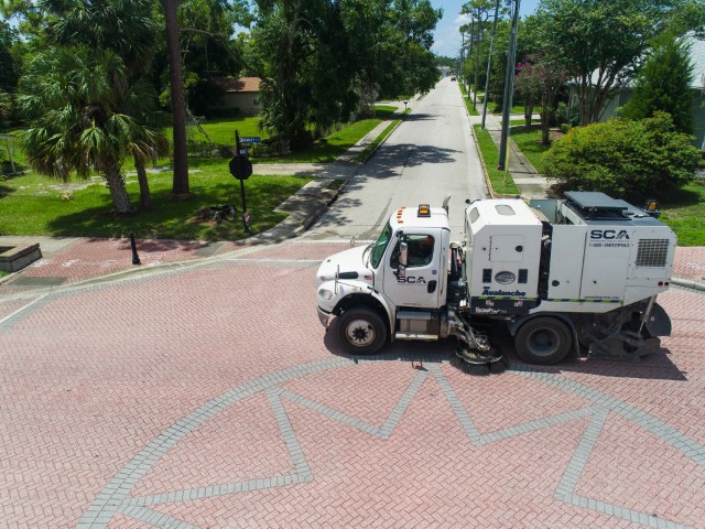 One of SCA's residential street sweepers sweeping a intersection.
